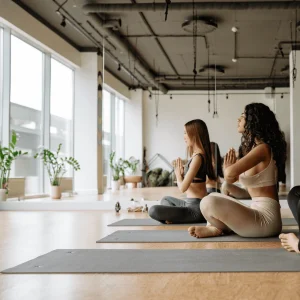 A group of people practicing yoga in a bright, spacious yoga studio